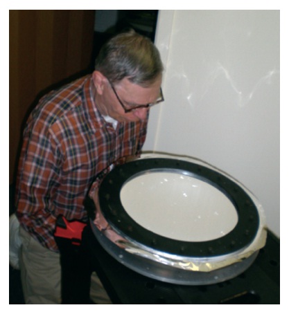 Recent image of Koch holding a 0.30 m (12 inch) aperture pneumatic mirror built at University of Pennsylvania in the early 1990’s.