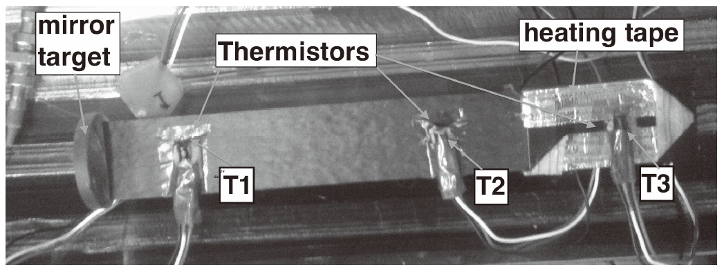 Opposite side of the specimen. Thermistor attachment configuration. A layer of thermo-conductive foam was created between the sensors and the specimen. The thermistors attachment points are: T1 at 20 mm from the left side, T2 at 30 mm from the metal part, T3 at 25 mm from the right side.