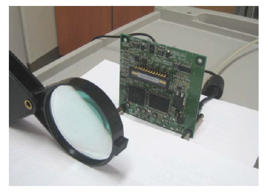 Visible light communication receiver part using an image sensor, a driver circuit, and a lens.