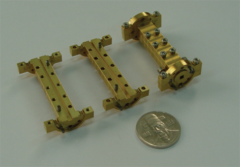 Two halves split-blocks of the square-to-WR10 waveguide transition (two on the left side) and assembled transition (on the right side).