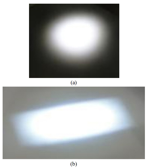 Comparison of illumination patterns between (a) the general surgical astral lamp and (b) the dental astral lamp. Note that the surgical astral lamp generates a circular pattern compared to the rectangular pattern of the dental astral lamp.